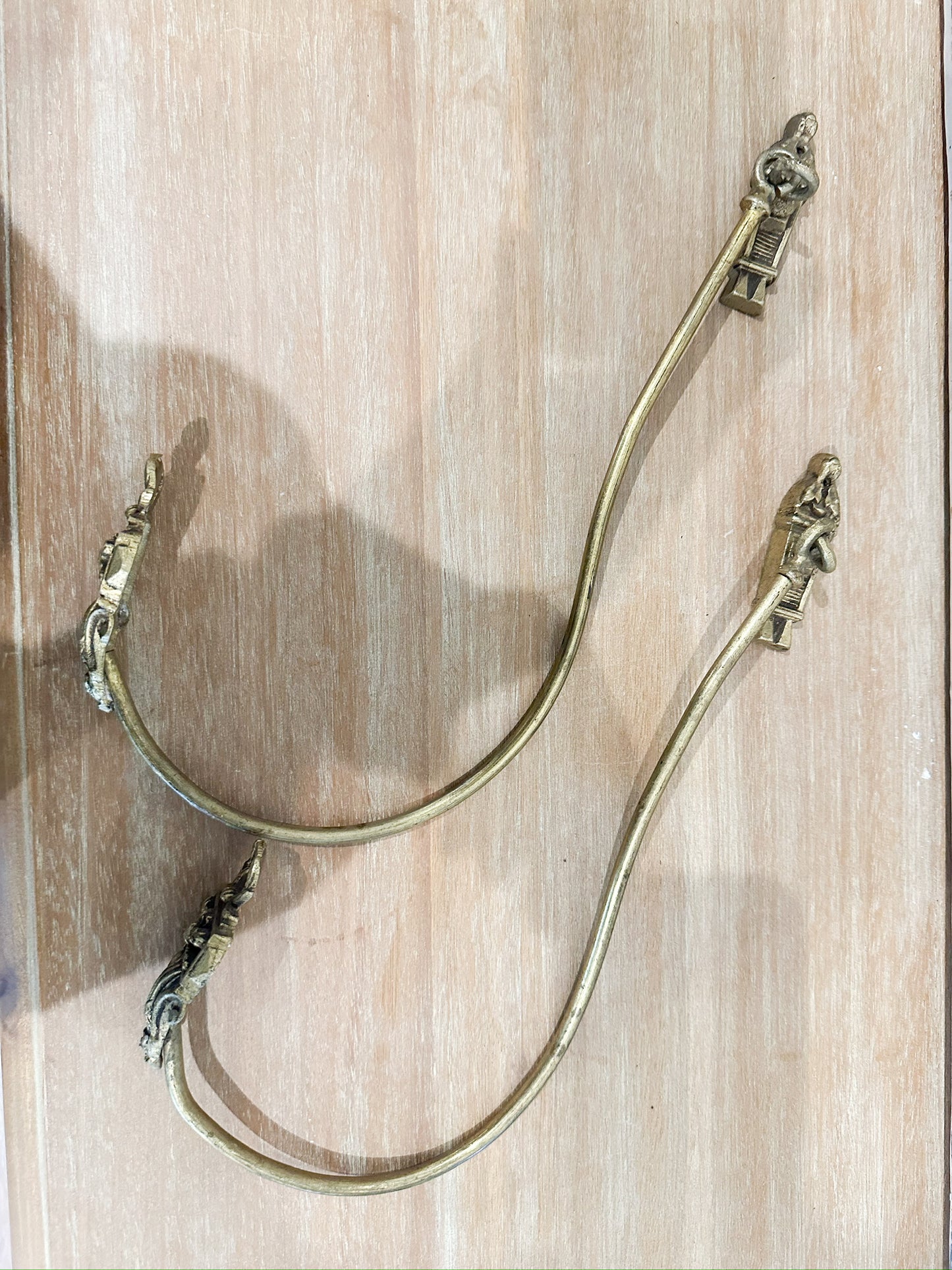 Pair of antique brass curtain tie-backs (Sold as a set)